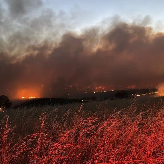 Gusty winds help spread fast growing central Oregon wildfire and prompt evacuations